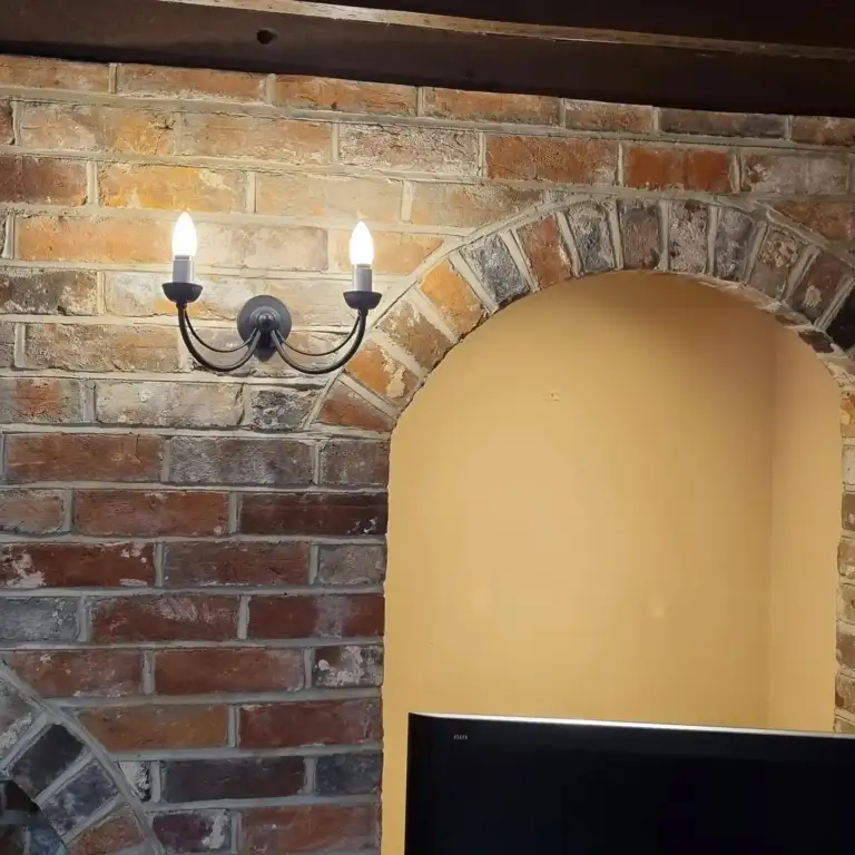 Fireplace opening with reclaimed timber beam and lime-hemp plaster finish