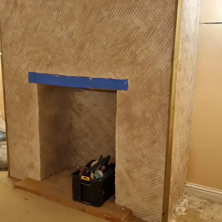Fireplace opening with reclaimed timber beam and lime-hemp plaster finish