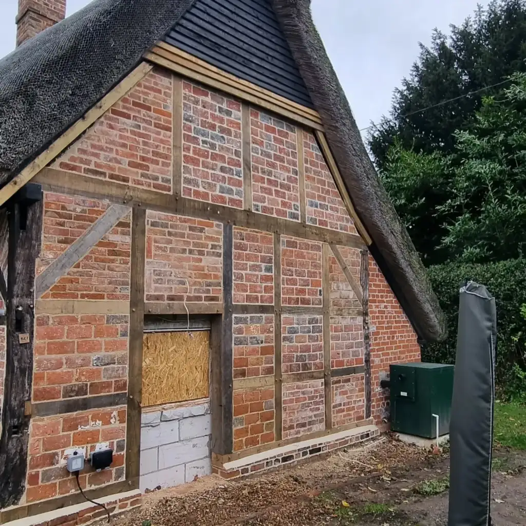 Timber-framed gable rebuilt with a new oak frame and brick infill, Inkpen