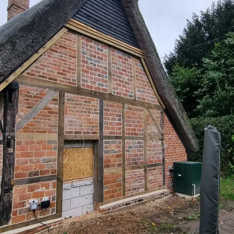 Timber-framed gable rebuilt with a new oak frame and brick infill, Inkpen